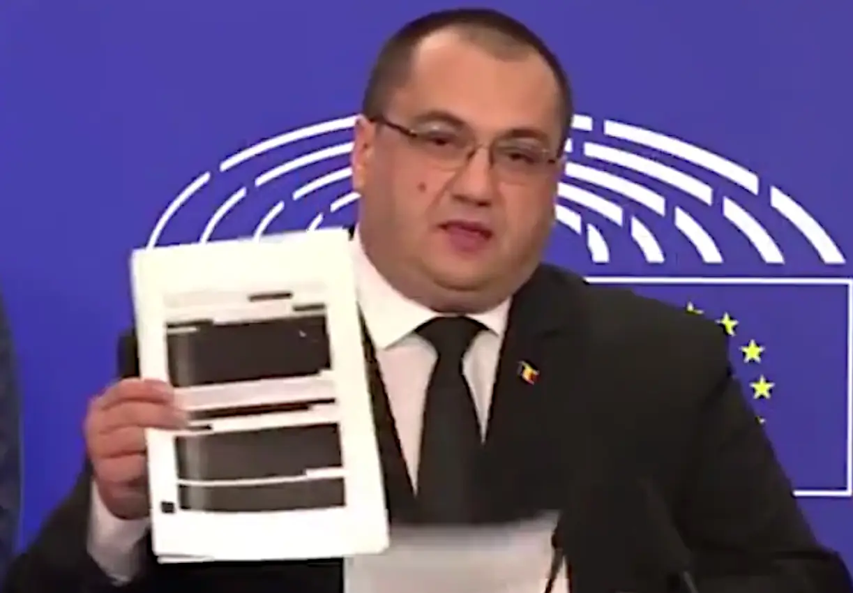 MEP Cristian Terhes, holding up a heavily redacted copy of a vaccine contract between a private corporation and the EU